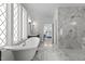 Bright bathroom featuring marble floors, standalone tub, and glass shower at 1225 Perry Bluff Dr, Wake Forest, NC 27587