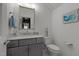 Half bathroom features granite countertop, gray vanity, and decorative mermaid statue at 1225 Perry Bluff Dr, Wake Forest, NC 27587