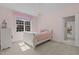 Charming bedroom with pink walls, chandelier, and a large window at 1225 Perry Bluff Dr, Wake Forest, NC 27587