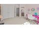 Carpeted bedroom features double closets, access to ensuite bath and pink desk with fuzzy chair at 1225 Perry Bluff Dr, Wake Forest, NC 27587