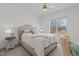 Bedroom features a tufted headboard, neutral color scheme, and a large window view at 1225 Perry Bluff Dr, Wake Forest, NC 27587