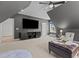 Upstairs bonus room with TV, storage, and natural light at 1225 Perry Bluff Dr, Wake Forest, NC 27587