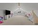 Spacious bonus room with vaulted ceiling, neutral carpet, ceiling fans, and window seat at 1225 Perry Bluff Dr, Wake Forest, NC 27587