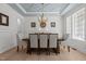 Elegant dining room with wainscoting, decorative ceiling, and chandelier creates a perfect ambiance for Gathering gatherings at 1225 Perry Bluff Dr, Wake Forest, NC 27587