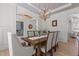 Dining room with wood table, elegant chairs, wainscoting, and views into office area at 1225 Perry Bluff Dr, Wake Forest, NC 27587