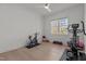 Bright exercise room featuring wood floors, a ceiling fan, and workout equipment next to a window at 1225 Perry Bluff Dr, Wake Forest, NC 27587