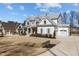 Beautiful home with a three-car garage, lush landscaping, and a well-maintained lawn and driveway at 1225 Perry Bluff Dr, Wake Forest, NC 27587