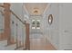 Elegant foyer with wood flooring, staircase, paneled walls, and a view of the front doors at 1225 Perry Bluff Dr, Wake Forest, NC 27587