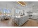 Bright and airy kitchen with large island, stainless steel appliances, dining area, and ample natural light at 1225 Perry Bluff Dr, Wake Forest, NC 27587