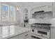 Bright kitchen with stainless steel oven, white cabinets, and marble countertops at 1225 Perry Bluff Dr, Wake Forest, NC 27587