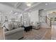 Beautiful living room showcasing an open floor plan, stairs, and stylish gray furniture with a plush ottoman at 1225 Perry Bluff Dr, Wake Forest, NC 27587
