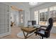 Bright office space with a large window, wood desk, and view of the home's entry at 1225 Perry Bluff Dr, Wake Forest, NC 27587