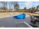 Aerial view of a backyard pool, with lounge chairs, patio, and view of a pond at 1225 Perry Bluff Dr, Wake Forest, NC 27587