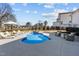 Sparkling blue swimming pool with a tanning ledge, surrounded by lounge chairs and lush landscaping at 1225 Perry Bluff Dr, Wake Forest, NC 27587