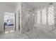 Elegant marble shower with glass enclosure and natural light at 1225 Perry Bluff Dr, Wake Forest, NC 27587