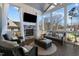 Relaxing sunroom with stone fireplace, tv, and seating with views of the backyard at 1225 Perry Bluff Dr, Wake Forest, NC 27587