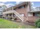 Exterior view of a brick apartment building with a staircase leading to the second floor at 130 S Estes Dr # F6, Chapel Hill, NC 27514