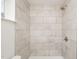 Close up of tiled walk-in shower with a shower head and a window at 130 S Estes Dr # F6, Chapel Hill, NC 27514