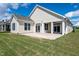 Spacious backyard featuring a covered patio with white pillars, perfect for outdoor entertaining at 133 Oban Dr, Homesite 151, Sanford, NC 27330