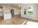 Open-concept dining area with modern lighting fixtures, large windows, and hardwood floors at 133 Oban Dr, Homesite 151, Sanford, NC 27330