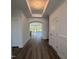 Bright hallway featuring wood floors, white walls, decorative lighting, and views to the living area at 133 Oban Dr, Homesite 151, Sanford, NC 27330