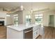 Open kitchen with a large island, stainless steel dishwasher, and views of the dining and living areas at 133 Oban Dr, Homesite 151, Sanford, NC 27330