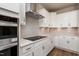 Modern kitchen with white cabinets, stainless steel appliances, and sleek countertops at 133 Oban Dr, Homesite 151, Sanford, NC 27330