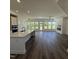 Open floor plan featuring a kitchen island and a bright living room with large windows and a fireplace at 133 Oban Dr, Homesite 151, Sanford, NC 27330