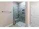 Modern shower with gray tile, a glass door, a built-in seat and niches, and updated fixtures at 133 Oban Dr, Homesite 151, Sanford, NC 27330