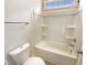 A bright bathroom features a white shower-tub combination with storage shelves and a chrome towel bar at 135 N Ridge View Way, Franklinton, NC 27525