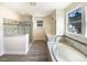Bright bathroom featuring a soaking tub, double vanity, and a separate glass shower at 135 N Ridge View Way, Franklinton, NC 27525