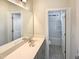Bathroom features a large mirror, vanity with storage, and a view into the shower-tub area at 135 N Ridge View Way, Franklinton, NC 27525