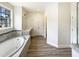 Bright bathroom featuring a soaking tub, double vanity, and separate glass shower at 135 N Ridge View Way, Franklinton, NC 27525