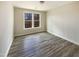 Well-lit bedroom with a large window and wood-style flooring at 135 N Ridge View Way, Franklinton, NC 27525