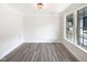 Well-lit bedroom with a large window and wood-style flooring at 135 N Ridge View Way, Franklinton, NC 27525