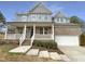 Charming two-story home with a welcoming front porch and a well-manicured lawn at 135 N Ridge View Way, Franklinton, NC 27525
