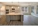 Modern kitchen boasts white cabinets, granite countertops, stainless appliances, and a central island at 135 N Ridge View Way, Franklinton, NC 27525