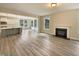 Open-concept living room with fireplace flows into a spacious kitchen featuring stainless appliances at 135 N Ridge View Way, Franklinton, NC 27525