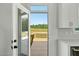Kitchen view of a private backyard with wooden deck and natural surroundings, open from the kitchen at 1467 Antioch Church Rd, Timberlake, NC 27583