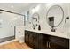 Stylish bathroom featuring a double vanity, modern fixtures, and a glass-enclosed shower with tiled walls at 1467 Antioch Church Rd, Timberlake, NC 27583