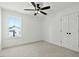 Bright bedroom with double doors, a ceiling fan, a window, and neutral carpet at 1467 Antioch Church Rd, Timberlake, NC 27583