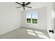 Well-lit bedroom with neutral carpet and a large window overlooking a green field at 1467 Antioch Church Rd, Timberlake, NC 27583
