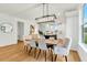 Bright dining area showcases stylish light fixture and adjacent open kitchen concept at 1467 Antioch Church Rd, Timberlake, NC 27583