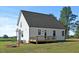 Back exterior view featuring a cozy back deck and well-manicured lawn at 1467 Antioch Church Rd, Timberlake, NC 27583