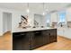 Bright kitchen island with modern hardware, pendant lighting, and a clear view to the backyard at 1467 Antioch Church Rd, Timberlake, NC 27583