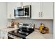 Modern kitchen featuring stainless steel appliances, white cabinets, and light backsplash at 1467 Antioch Church Rd, Timberlake, NC 27583