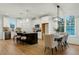 Open-concept kitchen with modern appliances, island seating, and adjacent dining area at 1467 Antioch Church Rd, Timberlake, NC 27583