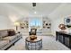 Inviting room with large bookshelves, comfortable sofa, accent chair, and modern decor at 1467 Antioch Church Rd, Timberlake, NC 27583