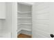 Bright pantry featuring custom, adjustable white shelving and wood flooring for organized storage at 1467 Antioch Church Rd, Timberlake, NC 27583