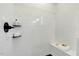 Modern shower with white tiled walls, black fixtures, and a built-in bench for a spa-like experience at 1467 Antioch Church Rd, Timberlake, NC 27583